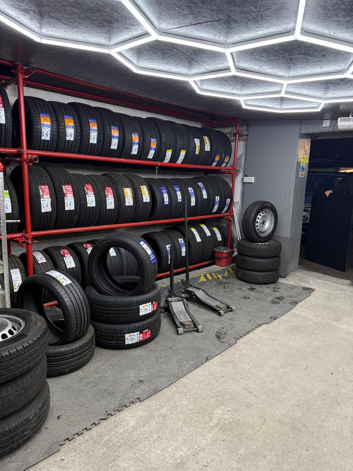Tyre stacks on red shelving racks at Platinum Tyres Doncaster